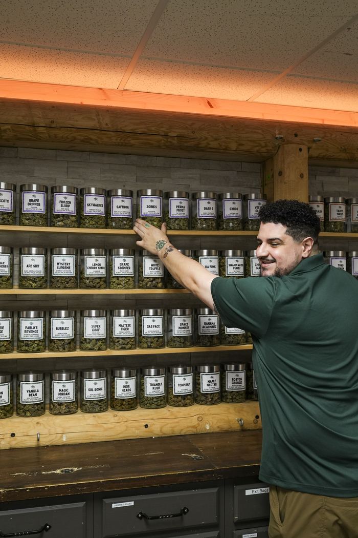 Northwest Cannabis Company budtender working the flower wall